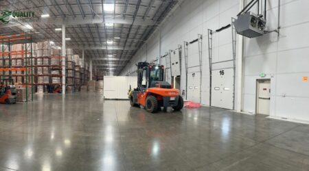 Modern 3PL warehouse filled with organized pallet racks and forklifts in operation.