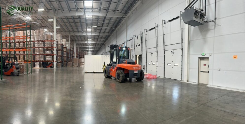Modern 3PL warehouse filled with organized pallet racks and forklifts in operation.